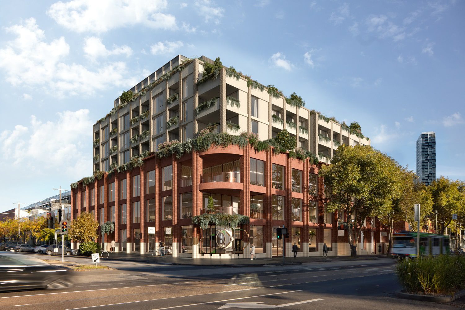 Modern urban building with greenery on the facade located at a busy city intersection under a blue sky